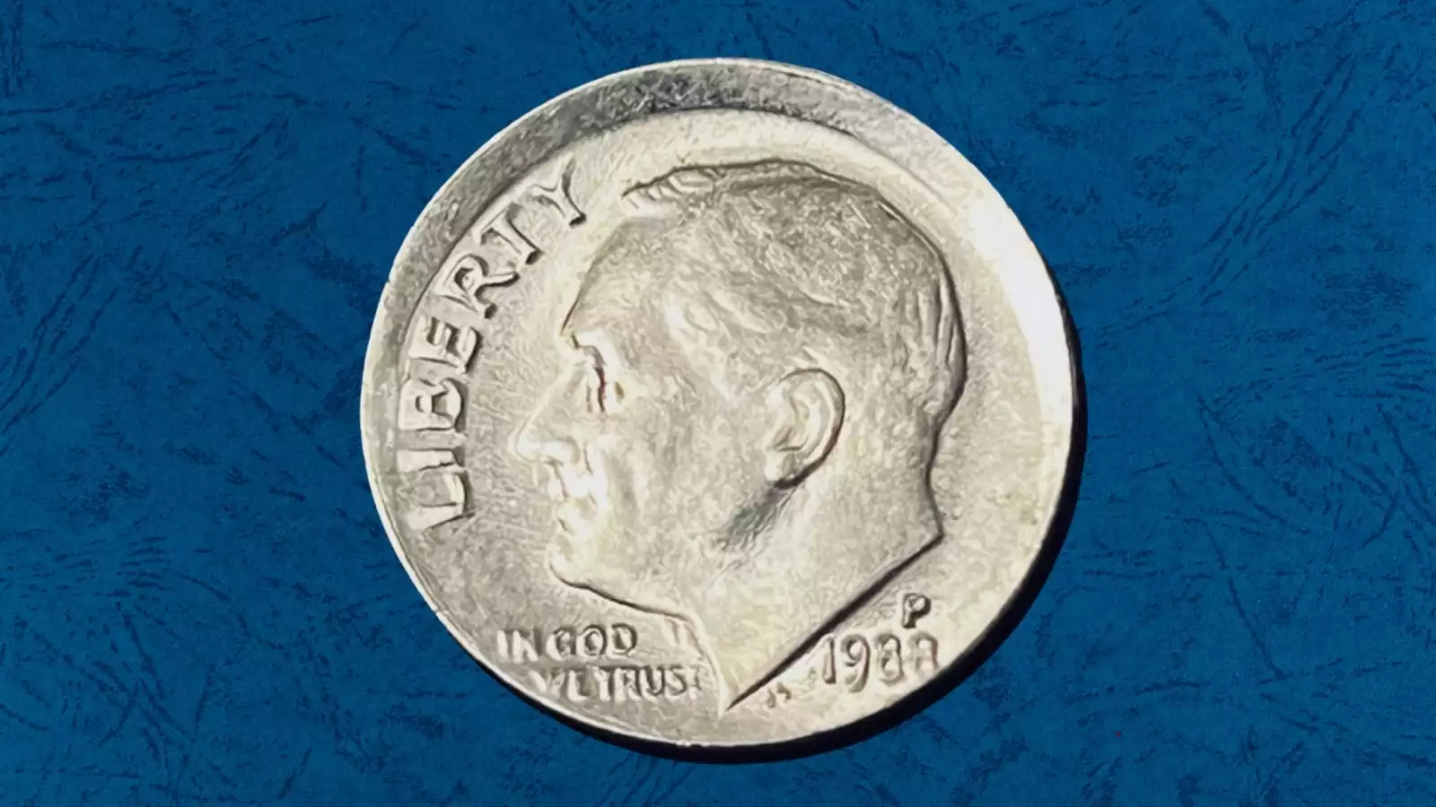 1988 dime off-center strike error showing shifted design and blank planchet area