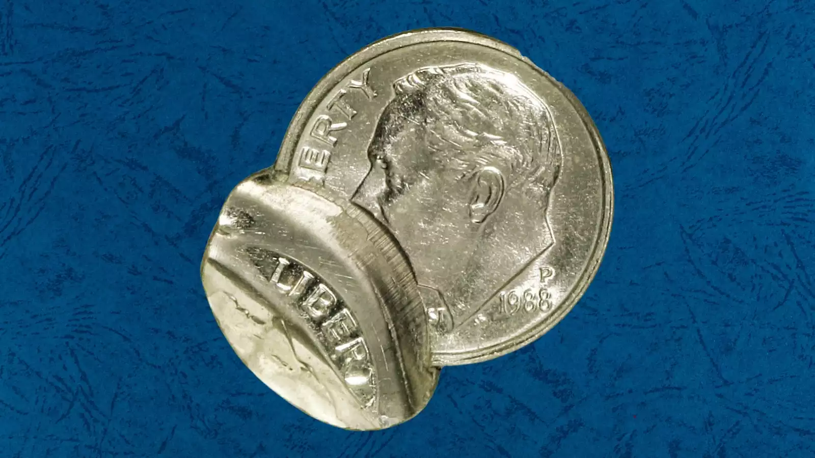1988 dime broadstrike error showing wider-than-normal diameter and missing reeded edge